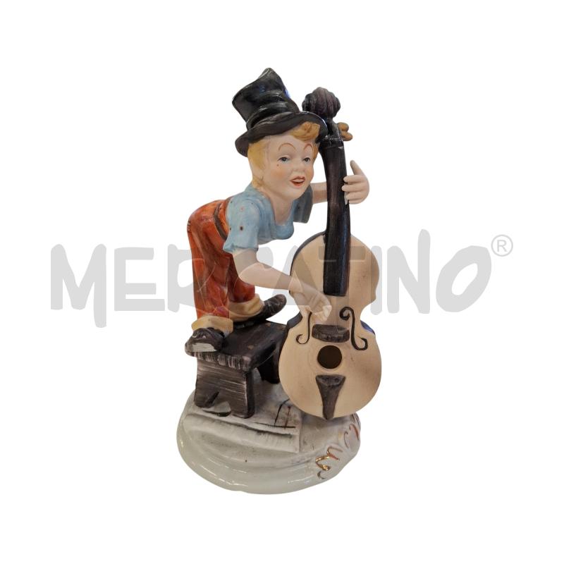 STATUINA PORCELLANA RAGAZZO CHE SUONA IL BASSO | Mercatino dell'Usato Roma zona marconi 1